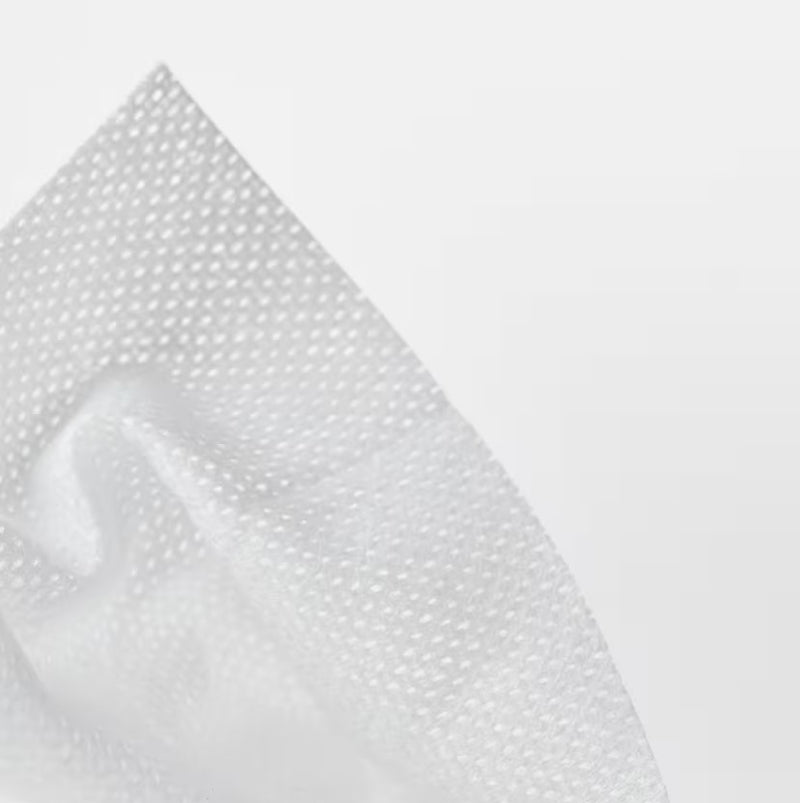 Close-up of white fabric with a subtle pattern on a light gray background